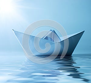 Paper ship in water and sunny blue sky