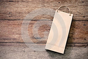 Paper shopping bag on wooden