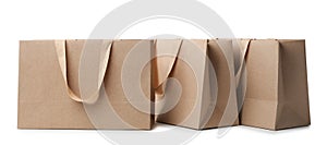 Paper shopping bags with comfortable handles on white background.