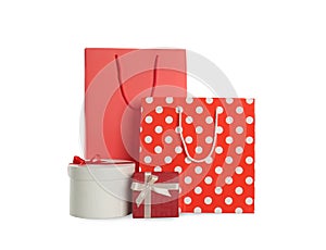 Paper shopping bags and gift boxes isolated on white