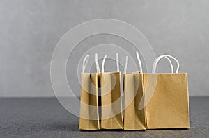 Paper shopping bags on granite floor and grey wall,e-commerce or electronic commerce is a transaction of buying or selling goods