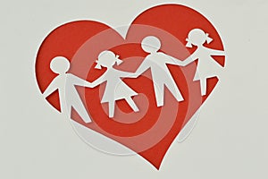 Paper silhouette of children in a heart - Child protection and l