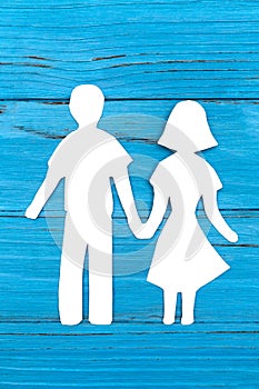 Paper silhouette of man and woman holding hands