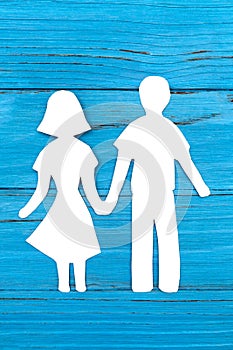 Paper silhouette of man and woman holding hands