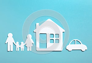 Paper silhouettes of family, house and car on color background, flat lay.