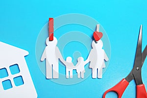 Paper silhouettes of family with pins, house and scissors on color background, flat lay. Life insurance