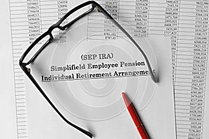 Paper with Simplified Employee Pension Individual Retirement Arrangement SEP IRA on a table