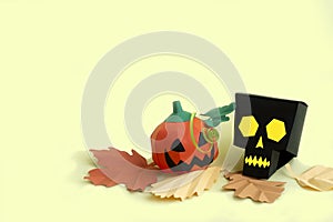 Paper skull and Jack-o-lantern with autumn leaves