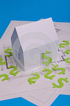 Paper skyscrapers , us dollar money, house projects plan and blueprints on blue background paper. Minimalistic and simple concept