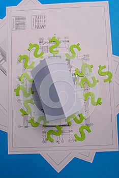 Paper skyscrapers , us dollar money, house projects plan and blueprints on blue background paper. Minimalistic and simple concept