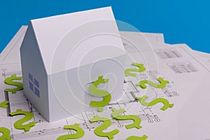 Paper skyscrapers , us dollar money, house projects plan and blueprints on blue background paper. Minimalistic and simple concept