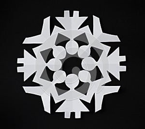 PAPER SNOWFLAKE CUT AS PEOPLE HOLDING THEIR HANDS photo
