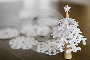 Paper snowflakes christmas tree on wood table