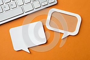 Paper speech bubble in rectangle shape on orange background photo