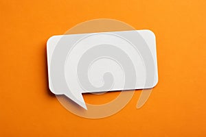 Paper speech bubble in rectangle shape on orange background photo
