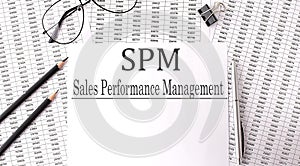 Paper with SPM - Sales Performance Management on a table on charts