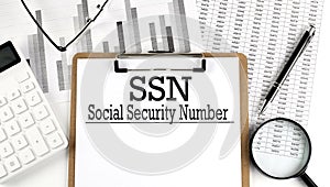 Paper with SSN - Social Security Number a table on charts, business concept