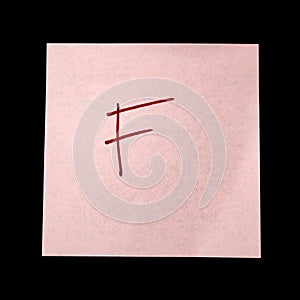 Paper sticker with the image of the letter f on dark background