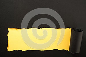 Paper strip torn black yellow background horizontal bottom edge