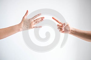 Paper symbol and nail symbol in playing rock paper scissors game on white background