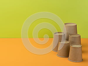 Paper tableware in the orange and light green background