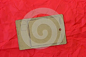 Paper tag on red crumpled paper background