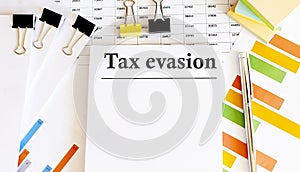 Paper with TAX EVASION on a table photo