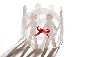 Paper team linked together with red bow photo