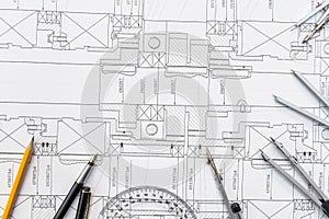 Paper with technical drawings and work tool on table. place of work