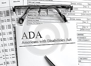 Paper with text ADA Americans with Disabilities Act on a table photo