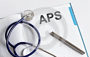 Paper with text APS on a table with stethoscope