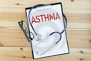 Paper with text ASTHMA on a table with stethoscope. photo