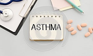 text ASTHMA on a table with stethoscope. Medicina photo