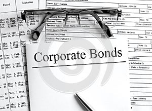 Paper with text Corporate Bonds a financial tables with glasses