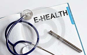 Paper with text E-HEALTH on a table with stethoscope