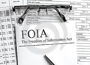 Paper with text FOIA The Freedom of Information Act on a table