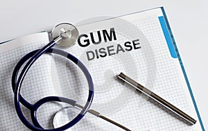 Paper with text GUM DISEASE on a table with stethoscope