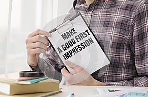 Paper with text MAKE A GOOD FIRST IMPRESSION .
