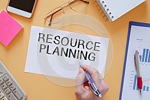 Paper with text RESOURCE PLANNING near office supplies