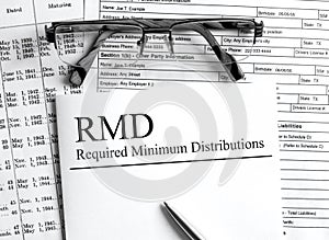 Paper with text RMD Required Minimum Distributions on a table photo