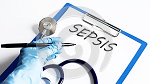 Paper with text SEPSIS on a table with stethoscope photo