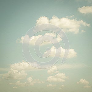 Paper texture background of retro style blurred sky with soft clouds