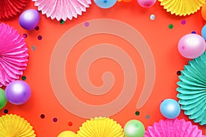 Paper texture flowers with different baloons on orang background. Birthday, holiday or party background. Flat lay style.