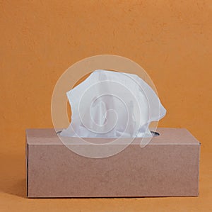 Paper tissue box on orange background