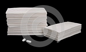 Paper tissues and aspirins - isolated on black photo