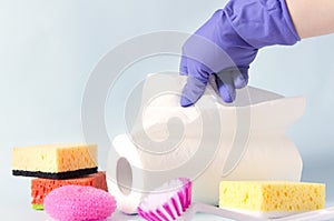 Paper towels,sponges,cleaning brush,scourer, woman in protective gloves.Concept of cleaning