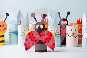 Paper toy Happy Easter home party. Easy crafts for kids on blue background, copy space, die creative idea from toilet tube roll,