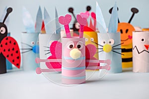 Paper toy Happy Easter home party. Easy crafts for kids on blue background, copy space, die creative idea from toilet tube roll,