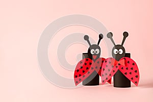 Paper toy ledybug for valentine romance baby shower, birthday party. Easy crafts for kids on pink background, copy space, diy