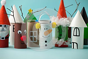 Paper toy Santa, Snowman, Grinch for Xmas party. Easy crafts for kids on blue background, copy space, die creative idea from